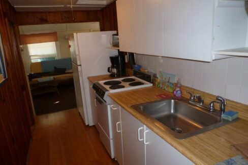 a kitchen with a stove top oven next to a sink.