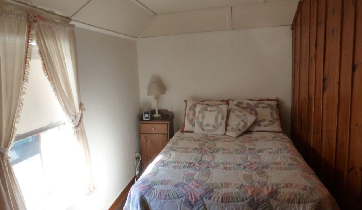 a bed sitting in a bedroom next to a window.