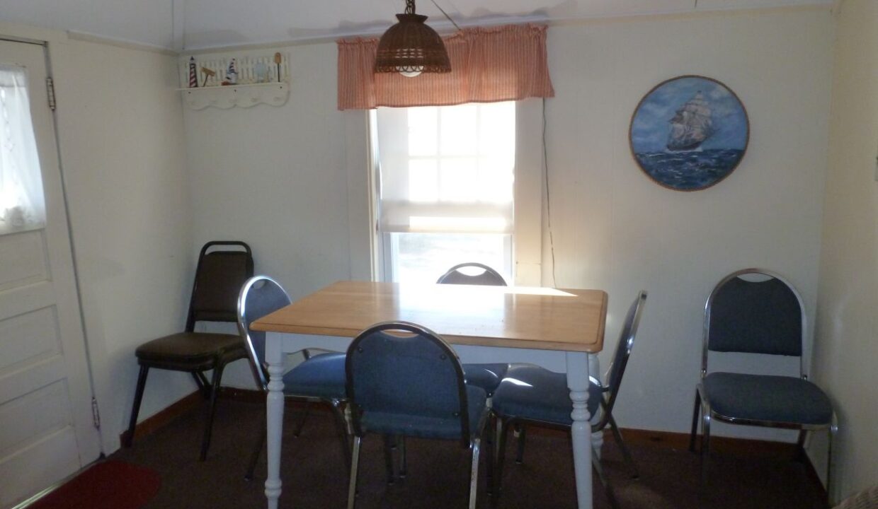 a dining room with a table and chairs.