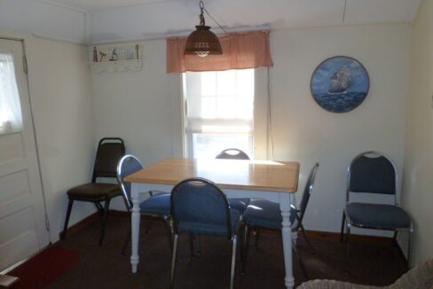 a dining room with a table and chairs.