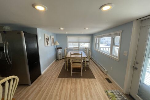 a kitchen with a table and chairs and a refrigerator.