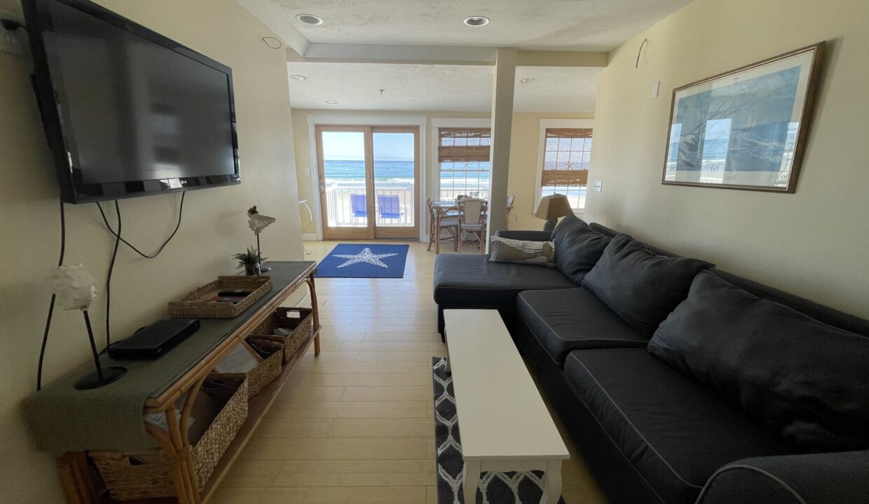 a living room filled with furniture and a flat screen tv.