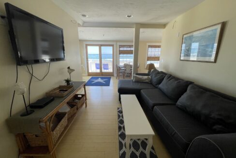 a living room filled with furniture and a flat screen tv.