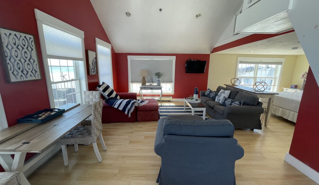 a living room filled with furniture and a flat screen tv.