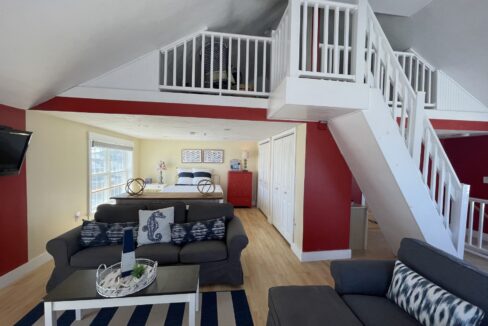 a living room filled with furniture and a flat screen tv.