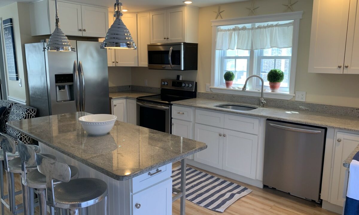 a kitchen with stainless steel appliances and white cabinets.