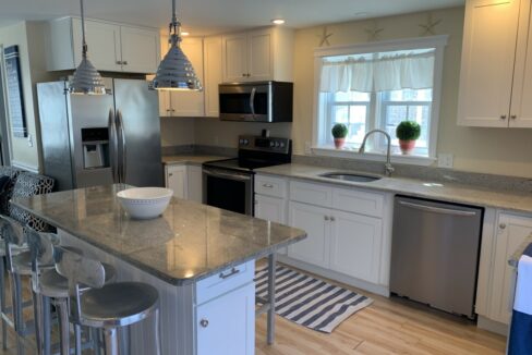 a kitchen with stainless steel appliances and white cabinets.