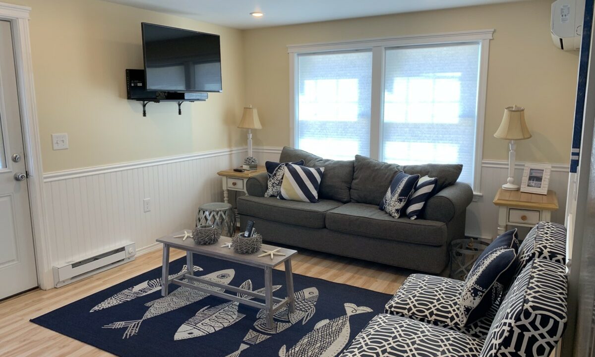 a living room filled with furniture and a flat screen tv.