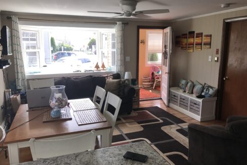 a living room filled with furniture and a laptop computer.