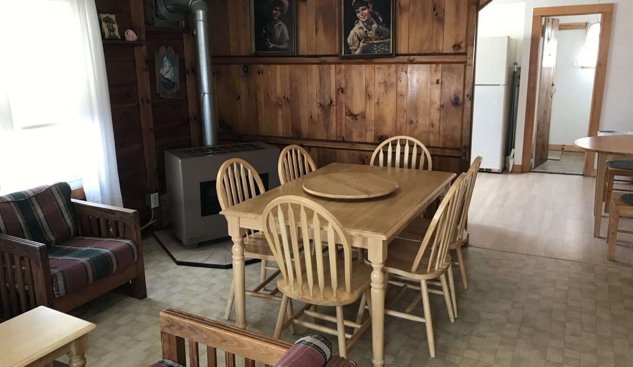 a living room with a couch a table and chairs.