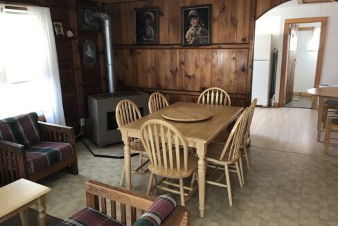 a living room with a couch a table and chairs.