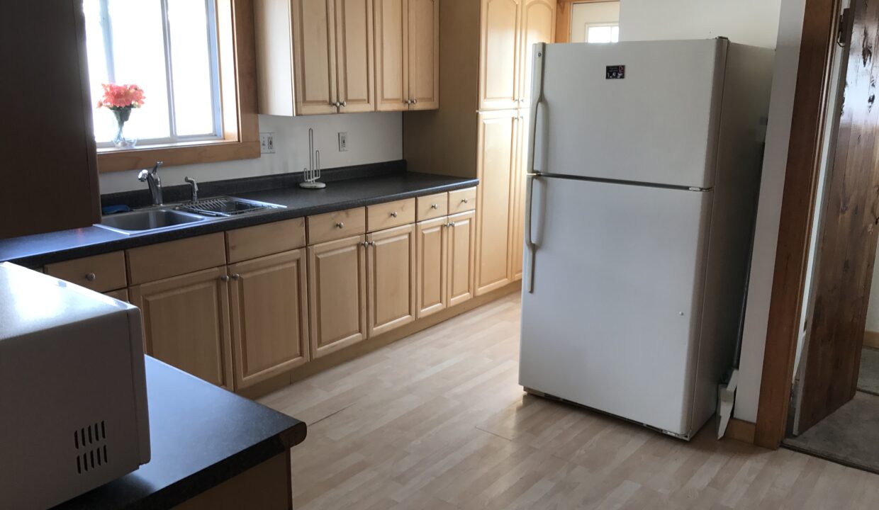 a white refrigerator freezer sitting inside of a kitchen.