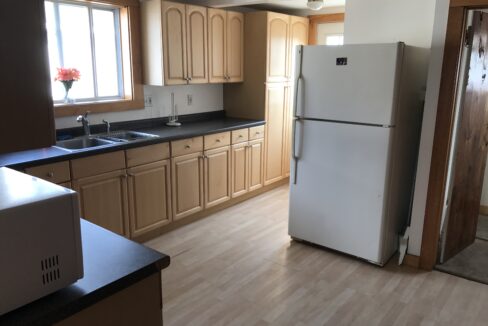 a white refrigerator freezer sitting inside of a kitchen.