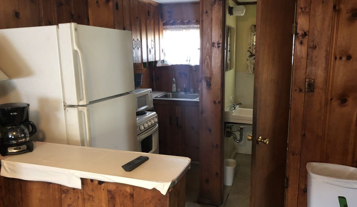 a kitchen with a refrigerator, stove and sink.