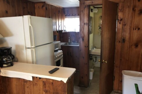 a kitchen with a refrigerator, stove and sink.