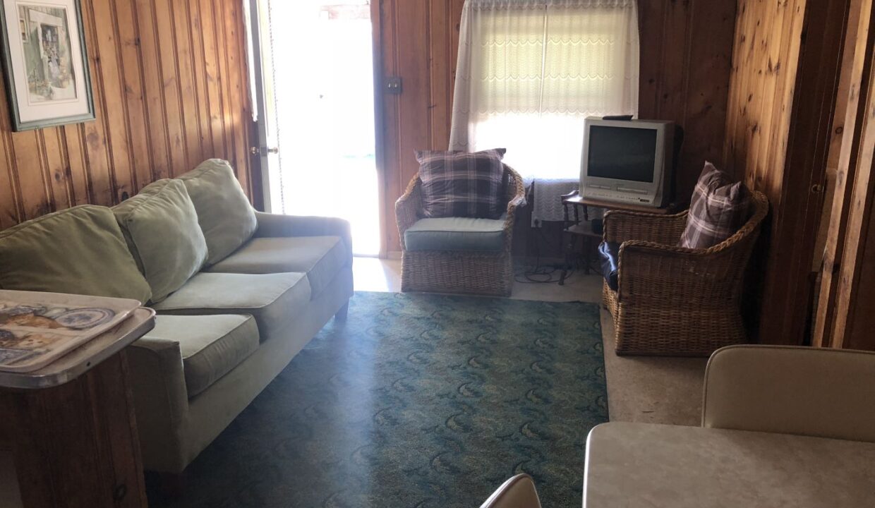 a living room filled with furniture and a flat screen tv.