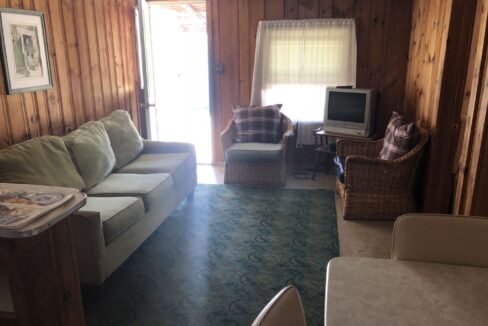 a living room filled with furniture and a flat screen tv.