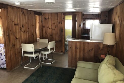 a living room with a couch a table and a tv.