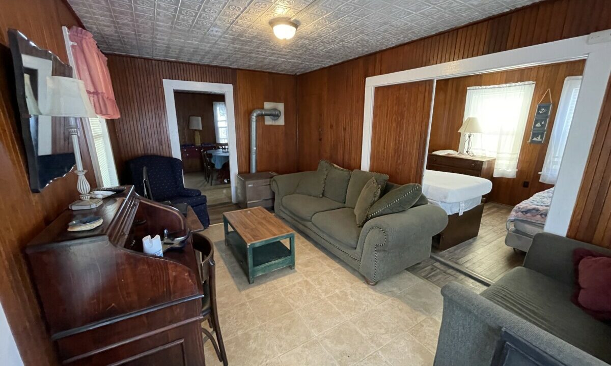 a living room filled with furniture and a flat screen tv.