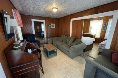 a living room filled with furniture and a flat screen tv.