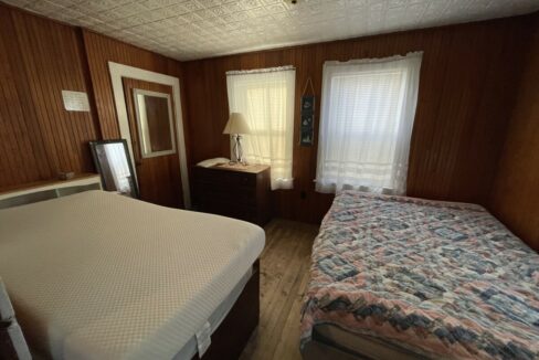 a bed sitting in a bedroom next to a window.