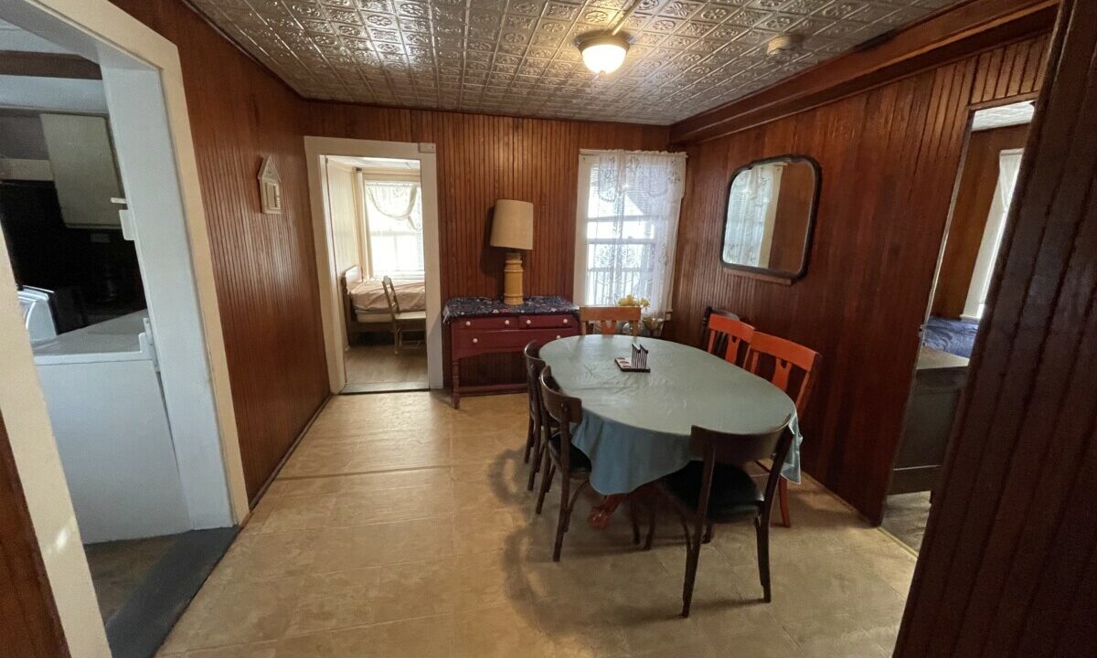 a dining room with a table and chairs.