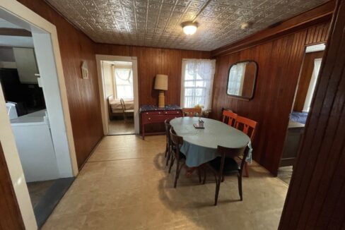 a dining room with a table and chairs.