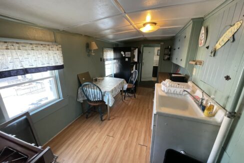 a kitchen and dining area of a mobile home.