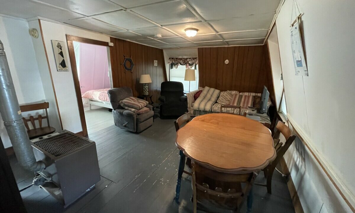 a living room filled with furniture and a wooden table.