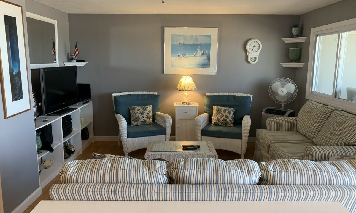 a living room filled with furniture and a flat screen tv.