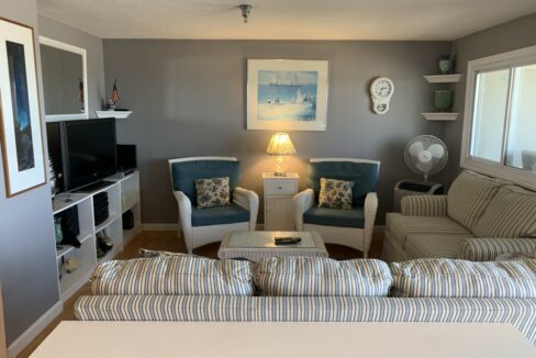 a living room filled with furniture and a flat screen tv.