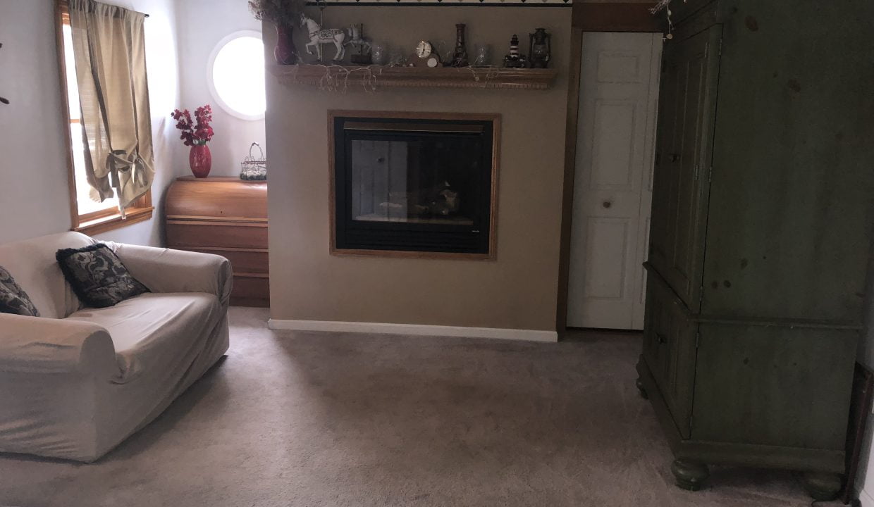 a living room filled with furniture and a fire place.