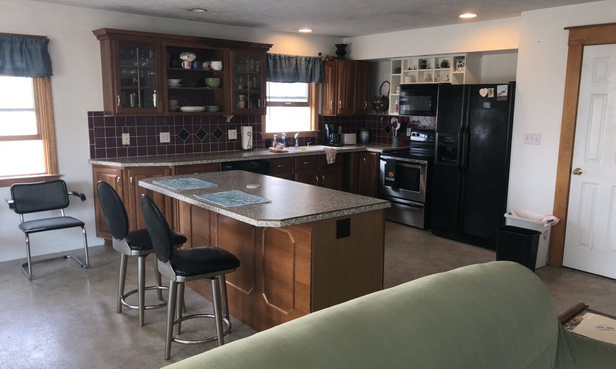 a kitchen and living room with a couch in it.