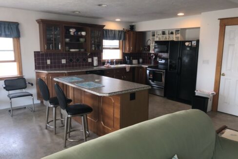 a kitchen and living room with a couch in it.