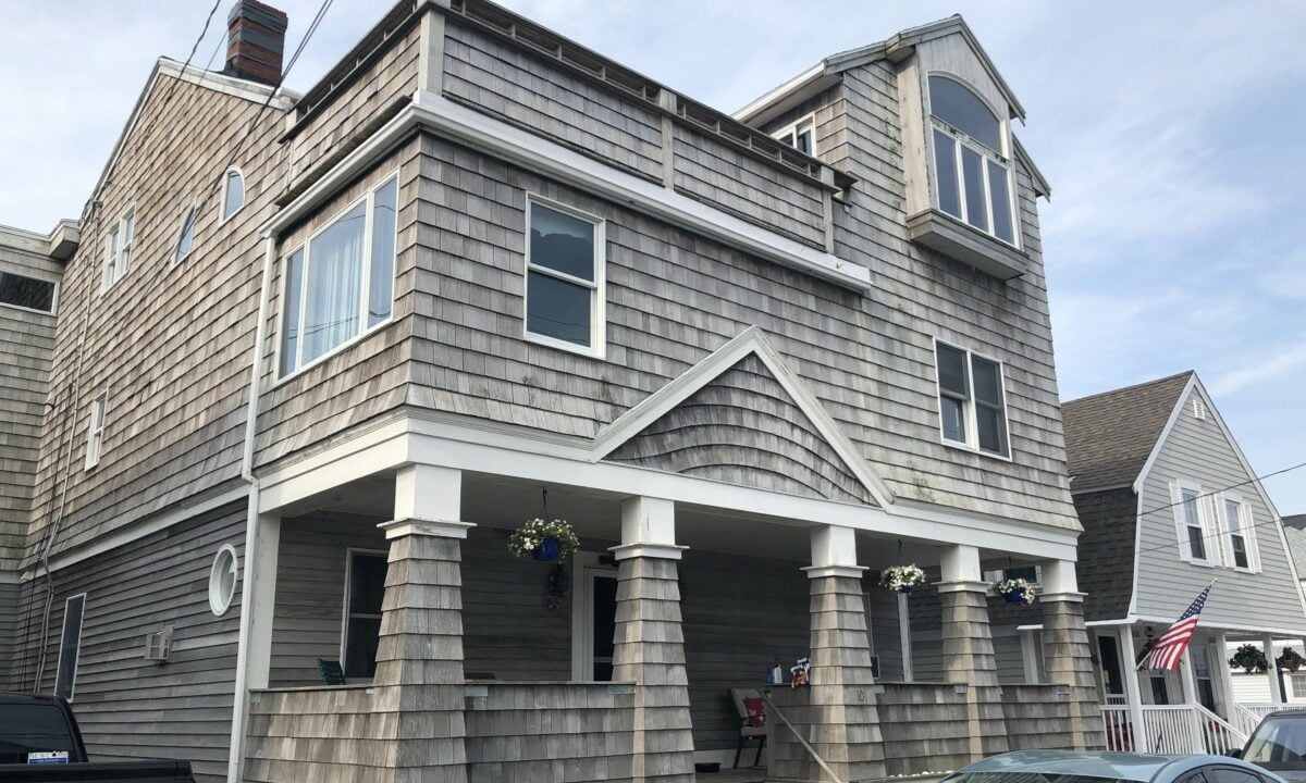 a car is parked in front of a house.