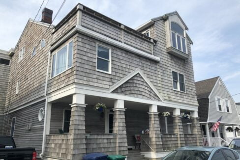 a car is parked in front of a house.