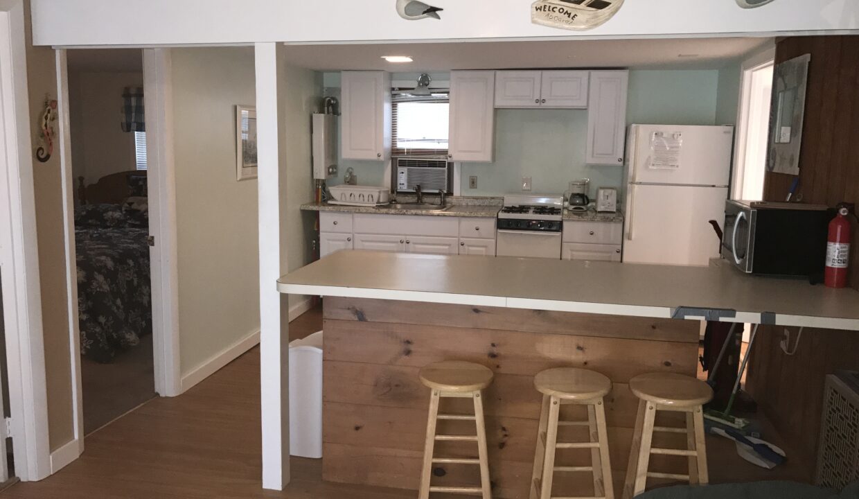 a kitchen with a bar and stools in it.