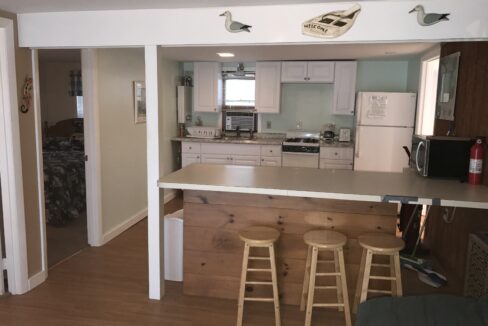 a kitchen with a bar and stools in it.