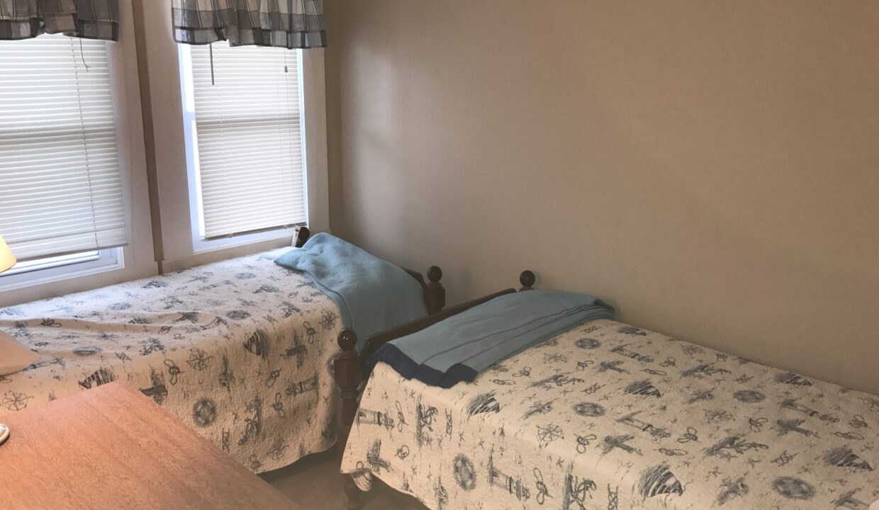 a couple of beds sitting next to each other in a bedroom.