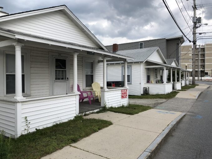 a row of white houses on a street corner.