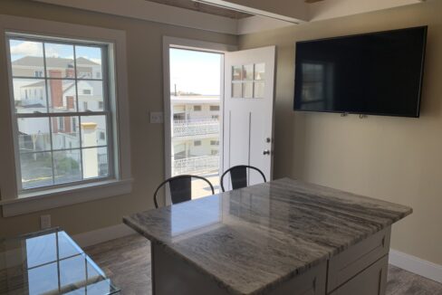 a kitchen with a tv mounted to the wall.