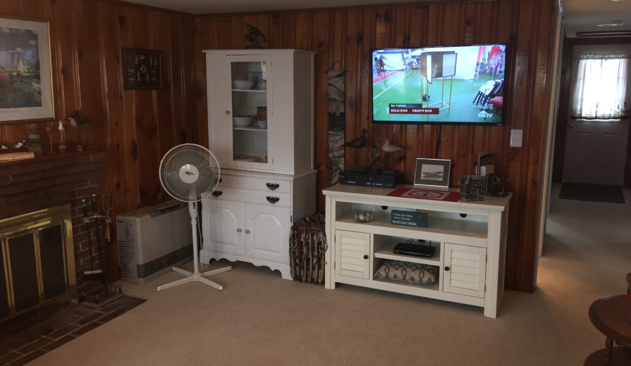 a living room filled with furniture and a flat screen tv.