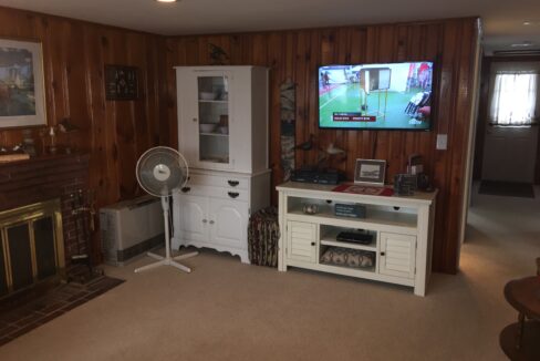 a living room filled with furniture and a flat screen tv.