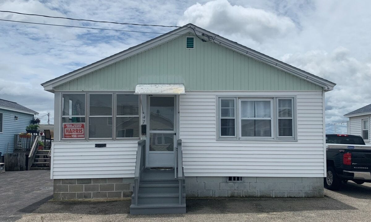 a small house with a truck parked in front of it.