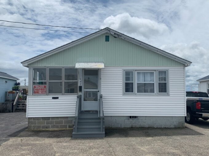 a small house with a truck parked in front of it.