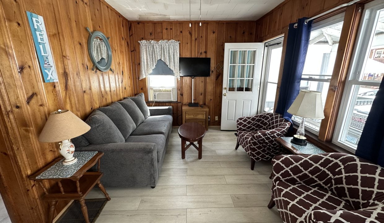 a living room filled with furniture next to a window.