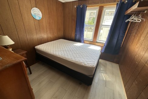 a bedroom with a bed and a desk in it.