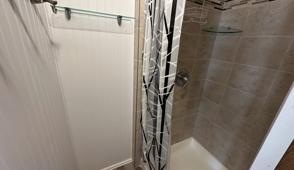 a walk in shower sitting next to a walk in shower.