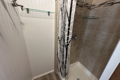 a walk in shower sitting next to a walk in shower.