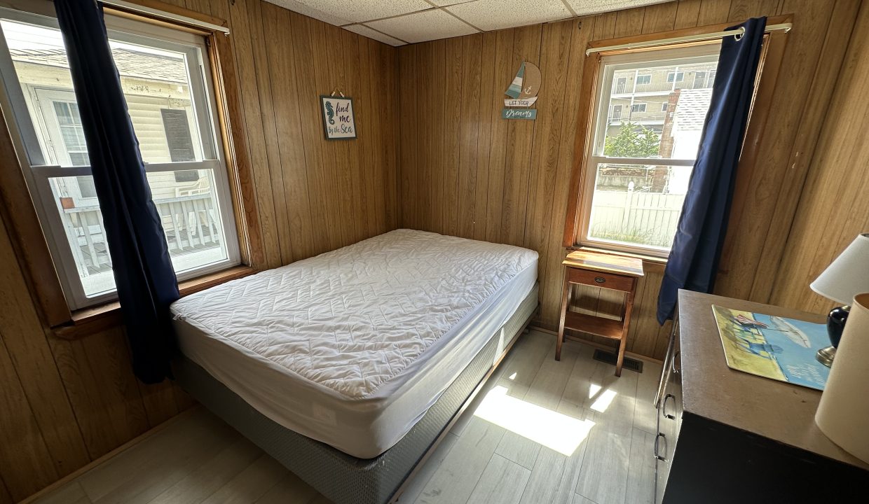 a bedroom with a bed and a desk in it.